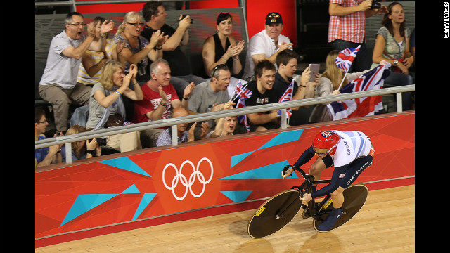 Jason Kenny of Great Britain is cheered on by spectators as he sets a new Olympic record during the men's sprint track cycling qualifying event. 