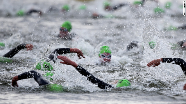 Athletes swim the first leg of the women's triathlon during Saturday.