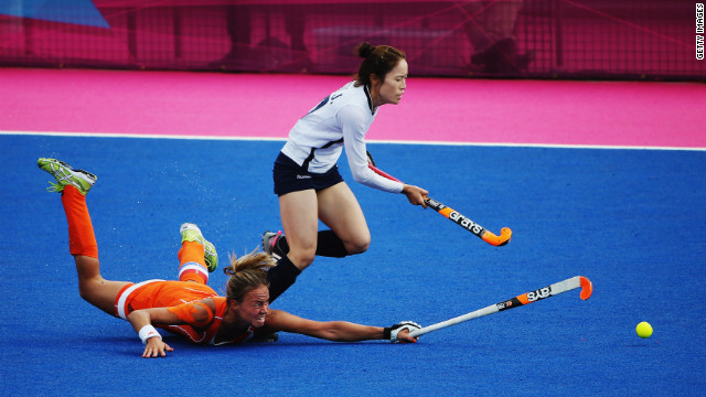 Captain Maartje Paumen of the Netherlands challenges Kim Jong Hee of South Korea during a women's hockey match.