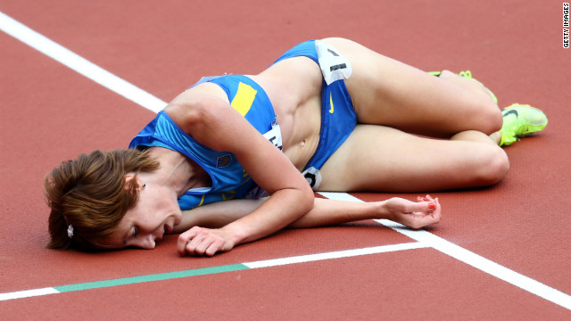 Valentyna Horpynych Zhudina of Ukraine lies on the track after competing in the women's 3000-meter steeplechase.