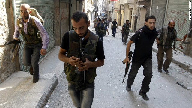 A Syrian rebel prepares his weapon as a group of Free Syrian Army fighters head toward the fighting with Syrian Army soldiers in the Salah ad-Din neighborhood of central Aleppo on Sunday, August 5.
