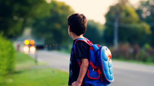 kid carrying backpack