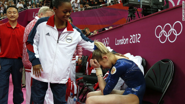 American gymnast Gabby Douglas, left, comforts Russia's Victoria Komova during the women's individual all-around competition. Douglas won the gold while Komova took silver.