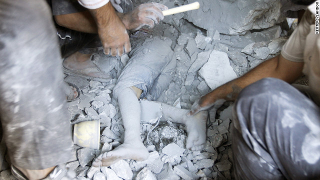 A boy's body is uncovered in the rubble of a house demolished during the recent clashes in Tel Rafat.