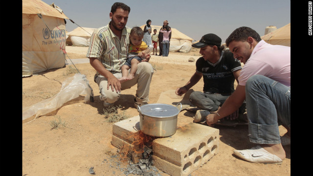 Syrian refugees cook a meal at Al Zaatari camp in Mafraq, Jordan.