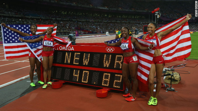 Carmelita Jeter, Bianca Knight, Allyson Felix and Tianna Madison of the United States celebrate next to the clock after winning gold and setting a new world record of 40.82 seconds in the women's 4x100m relay final.