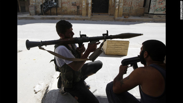 A Free Syrian Army fighter aims an RPG as he waits for Syrian army tanks in the Salaheddine neighborhood.