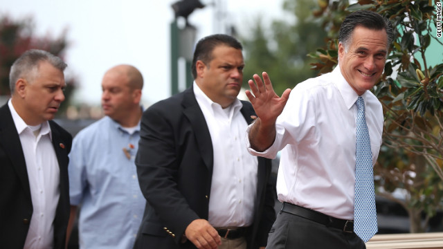 Romney waves at members of the media as he arrives at the USS Wisconsin to announce Ryan has his running mate.