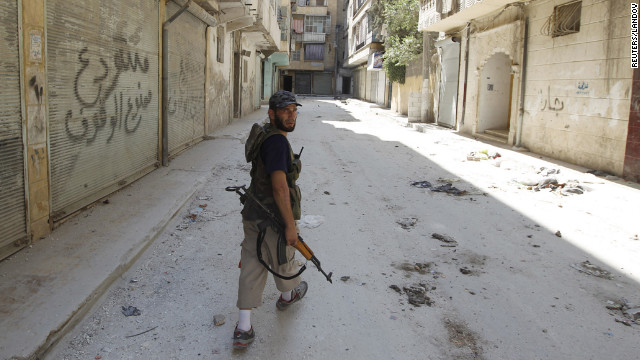 A Free Syrian Army fighter walks on an empty street in the Salaheddine neighborhood.