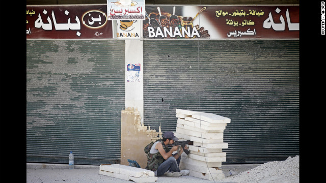 A Free Syrian Army fighter aims his rifle during heavy fighting in the Salaheddine neighborhood.