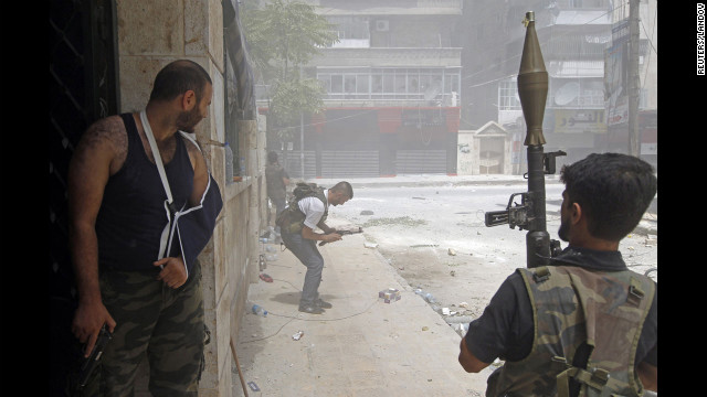 A Free Syrian Army fighter tries to fix his jammed rifle during heavy fighting in the Salaheddine neighborhood.