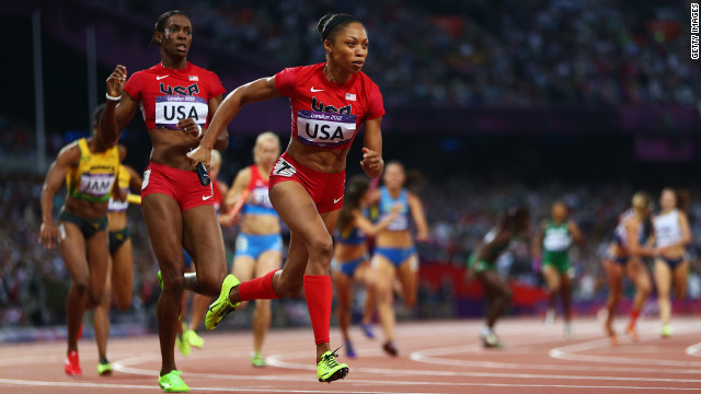 Allyson Felix receives the relay baton from DeeDee Trotter during the women's 4x400-meter relay final. 