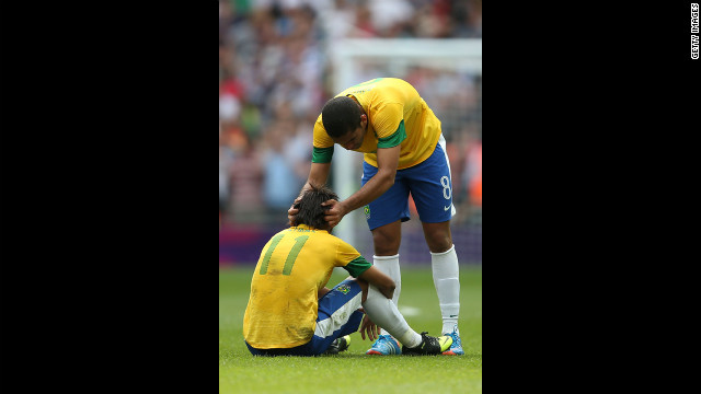 Brazilian soccer player Romulo adjusts a teammate's head with some on-field chiropractic.
