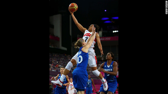 Maya Moore, in white, leaps for the basket against France's Florence Lepron in the second half.