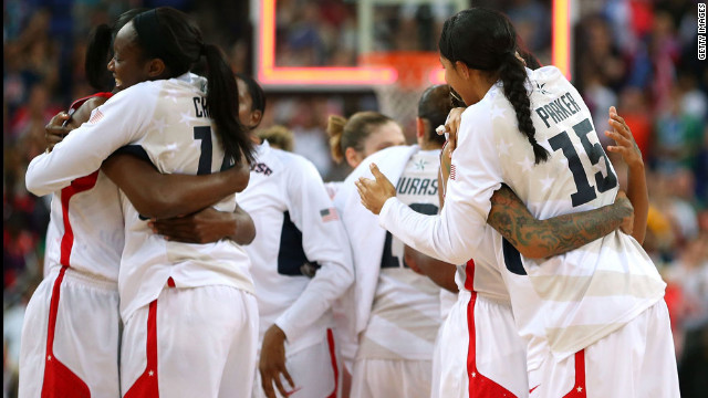 Members of the U.S. women's basketball team hug after defeating France.