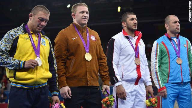 Standing on the podium after receiving their medals are, left to right, silver medalist Andriitsev, gold medalist Varner and bronze medalists George Gogshelidze of Georgia and Khetag Gazyumov of Azerbaijan.