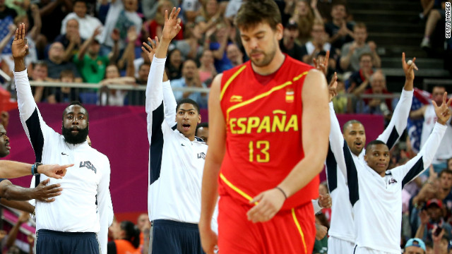 With victory in sight, U.S. players players come off the bench near the game's end as Marc Gasol of Spain walks off.