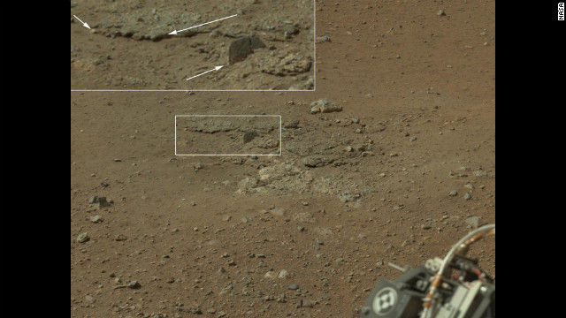 In this portion of the larger mosaic from the previous frame, the crater wall can be seen north of the landing site, or behind the rover. NASA says water erosion is believed to have created a network of valleys, which enter Gale Crater from the outside here.