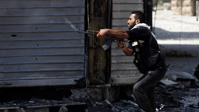 A Free Syrian Army fighter fires an AK-47 rifle in Aleppo on Wednesday, August 15.
