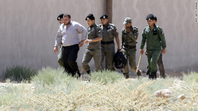Jordanian security officers detain a Syrian man after he tried to escape from the Zaatari refugee camp in Mafraq.