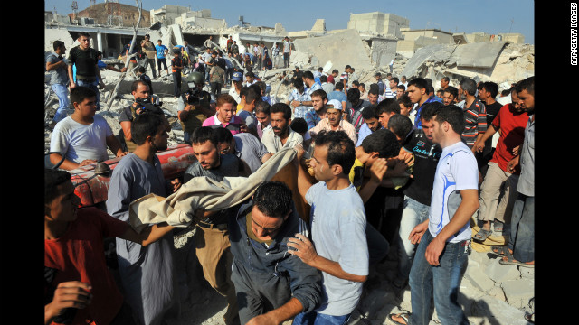 Syrians carry the body of a woman after an airstrike in Azaaz.