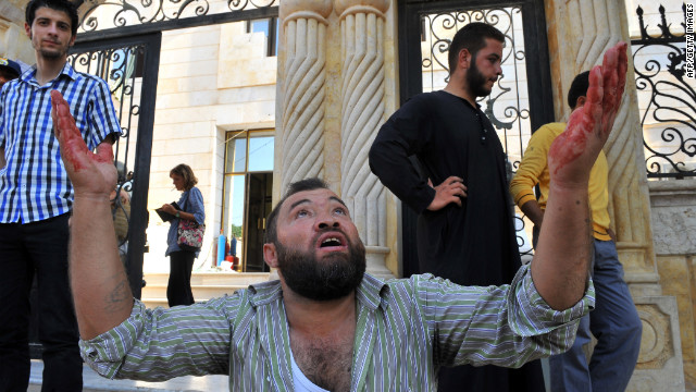 A Syrian man reacts after an airstrike in Azaaz.