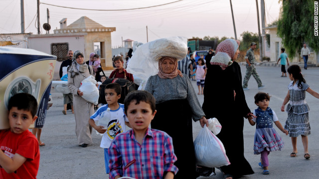 Syrians flee Azaaz following the airstrike.