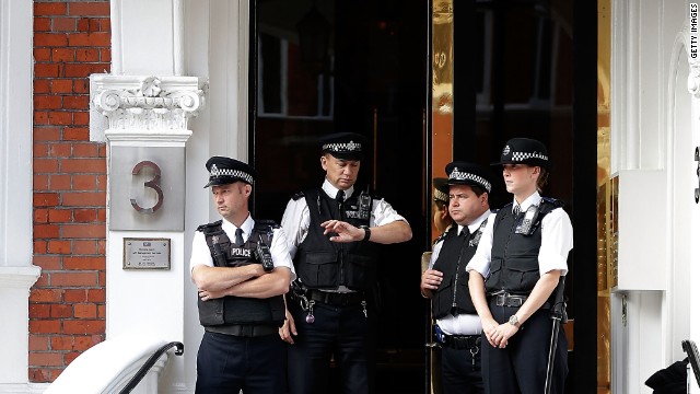 Police stand guard outside the entrance. The British government insists the UK still has a legal obligation to extradite Assange to Sweden.