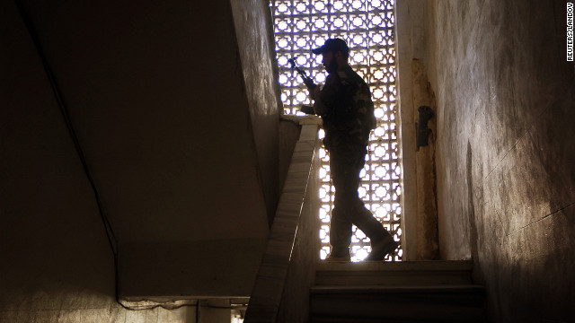 A rebel climbs some stairs in a building during clashes in central Aleppo's Salaheddine neighborhood. 