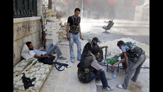 Free Syrian Army fighters rest Friday in Aleppo during a lull in fighting.