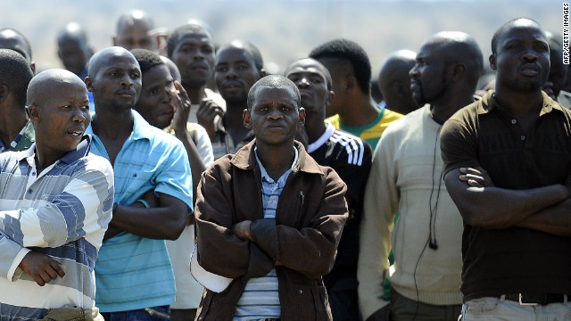 Striking workers gather on August 20 at the Lonmin-owned platinum mine in Marikana, 10 days after 3,000 miners began an illegal strike over pay.