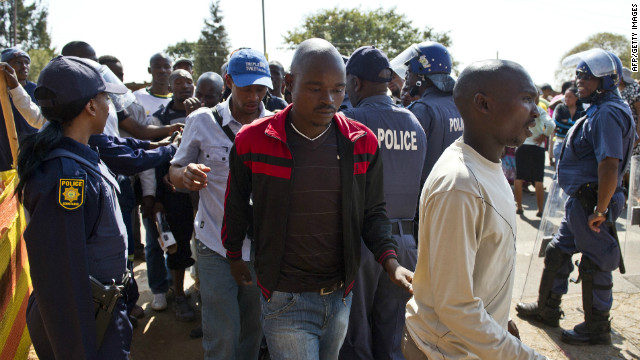 Miners arrested for allegedly being involved in violent clashes between striking workers and police are escorted from the Ga-Rankuwa courthouse, Pretoria, on August 20. 