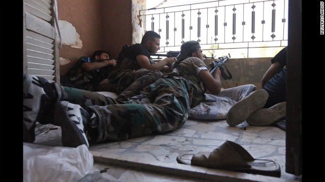Members of the Free Syrian Army take cover during clashes with Syrian Army soldiers on August 22.