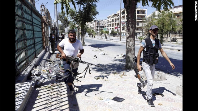 Syrian rebels run for cover during heavy fighting in the Saif al-Dawla district in the center of Aleppo on August 22.