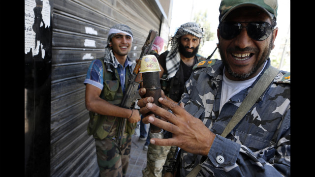  A Syrian rebel fighter holds a handmade bomb in the Saif al-Dawla district in the center of Aleppo on August 22. 