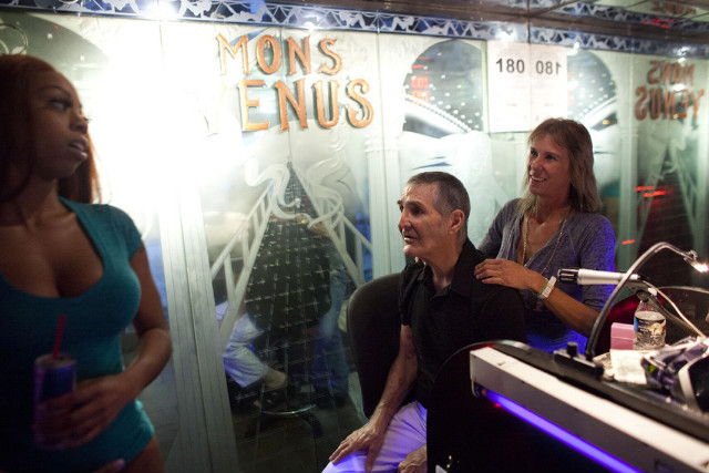 Club owner Joe Redner gets a back massage from Lorry Kasner at Mons Venus.