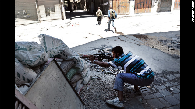 A Free Syrian Army fighter takes aim at regime forces during clashes in Aleppo.