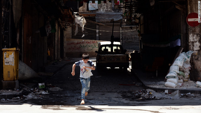 A young boy runs across the street during clashes between Free Syrian Army fighters and forces loyal to al-Assad.