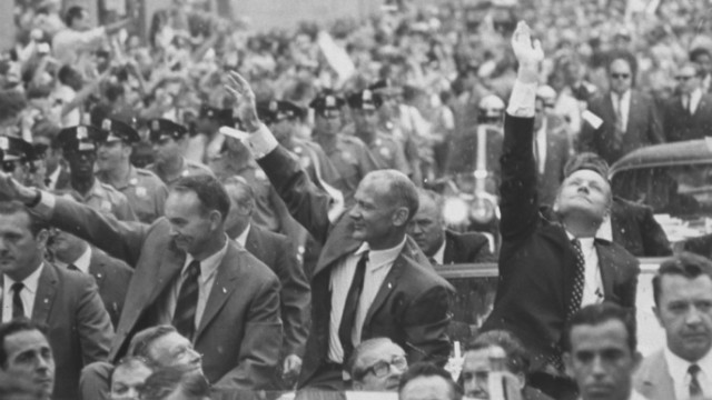 Armstrong, Aldrin and Collins wave to crowds at a parade held in August 1969 celebrating their voyage.