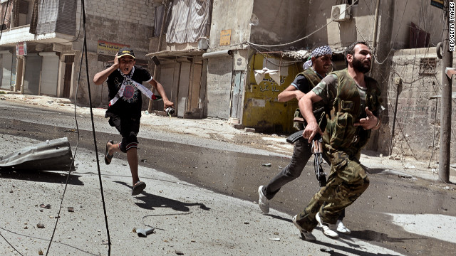 Rebel fighters run for cover during continued clashes with government forces in Aleppo on Saturday, August 25.