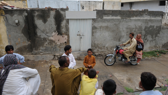 Pakistanis gather in Islamabad, Pakistan, on August 22 outside the closed house of a Christian girl accused of blasphemy.