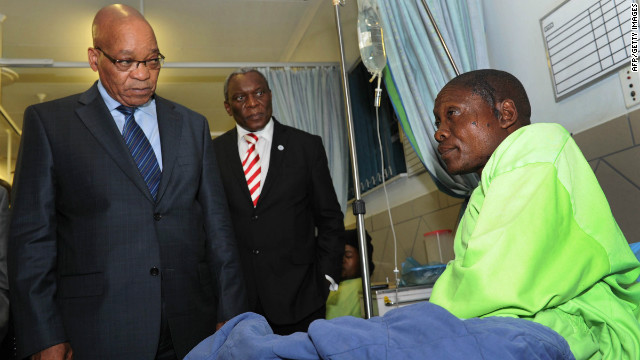 Miner Mfaseni Yekwayo, at a hospital near Rustenburg on August 18, relates to South African President Jacob Zuma, left, the events leading to the miners' clash with police.