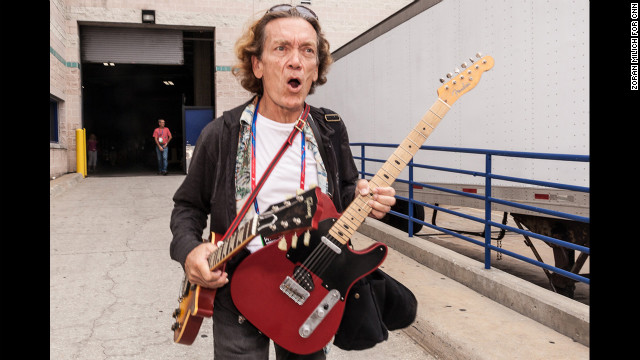 House band leader G.E. Smith arrives at the convention center Saturday with a pair of guitars.