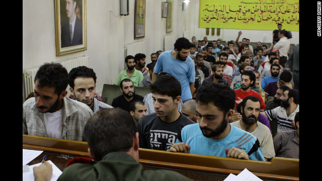 Men arrested for their involvement in anti-regime protests wait to be released in Damascus on Monday. The official Syrian news agency reported that authorities released 378 people detained for their participation in street protests, adding that those freed were never involved in acts of violence. 