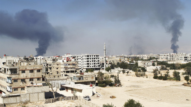 Smoke rises in the Damascus suburb of Ain Terma during clashes between Syrian rebels and pro-government forces.
