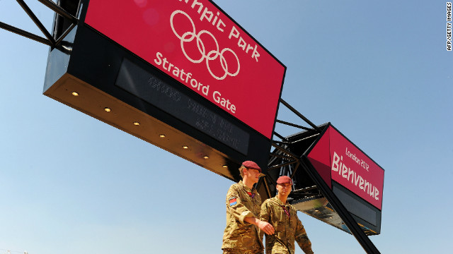 Soliders walk to their posts at the Olympic Stadium in London on July 24, 2012