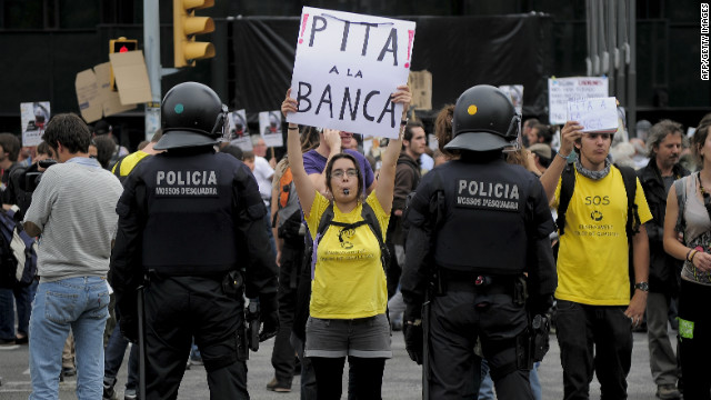 A woman holds a poster reading 'Lets boo the banks' at a Barcelona protest in May.