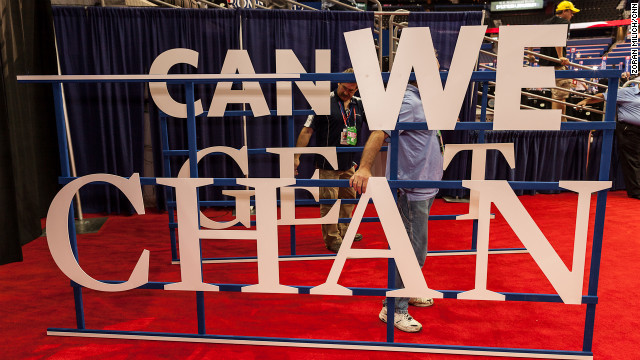 A worker changes the signs on the floor of the Republican National Convention on Wednesday.