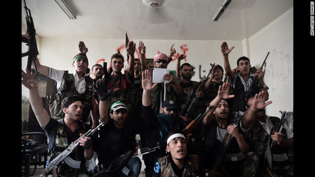 Syrian opposition fighters swear an oath for the liberation of Syria in Aleppo on Wednesday.