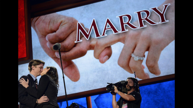 Laura Bowman accepts Bradley Thompson's proposal on the stage. Thompson is a production manager and Bowman is a production coordinator for the convention. 